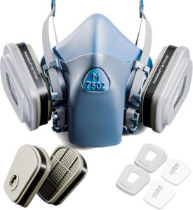 The complete M 7502 reusable half mask respirator kit, including the facepiece, ProDefend organic vapour cartridges, and particulate pre-filters with retainer covers.